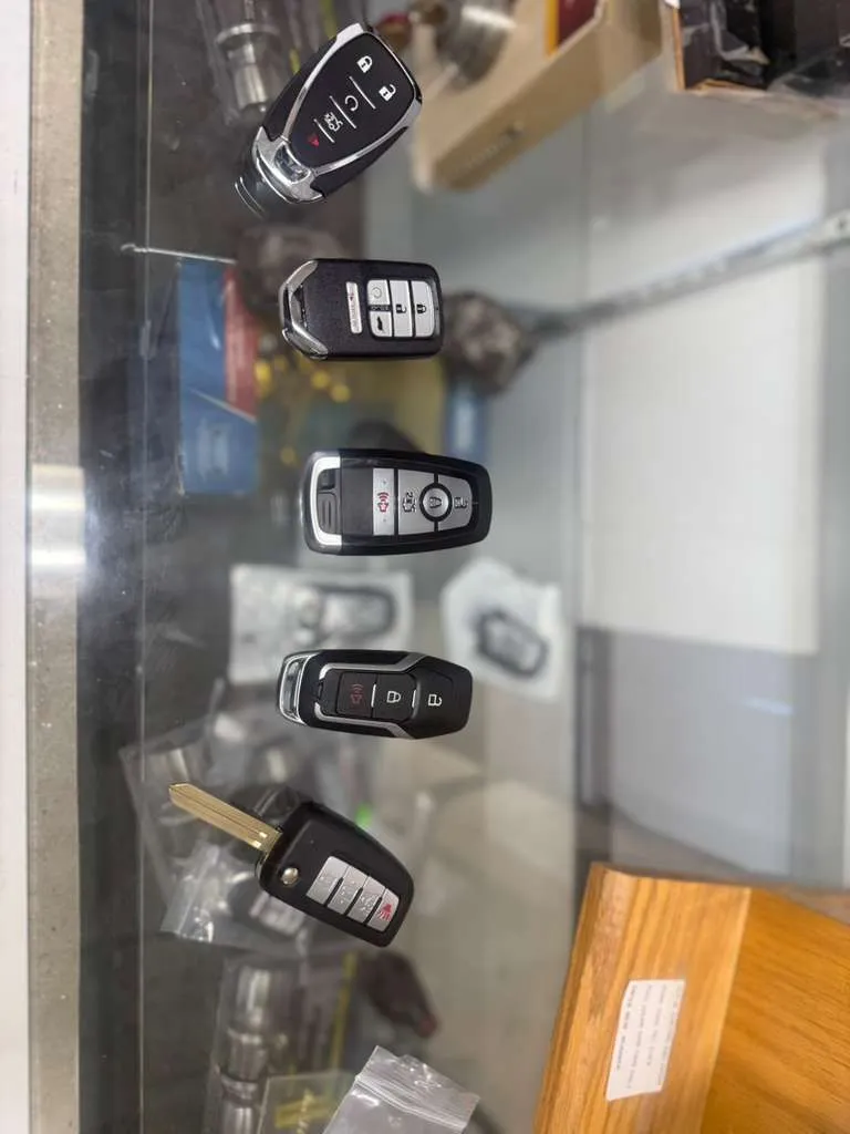 Five modern smart key fobs on the Locksmith Solutions OKC store counter